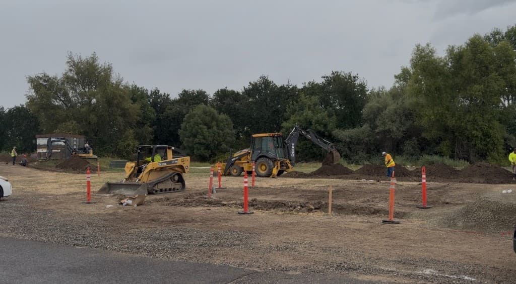 Construction site with heavy equipment breaking ground